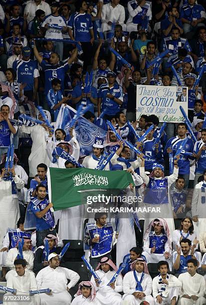 Saudi Al-Hilal club fans cheer for their team during their AFC Champions League match against Qatar's Al-Sadd club in Doha on February 24, 2010....