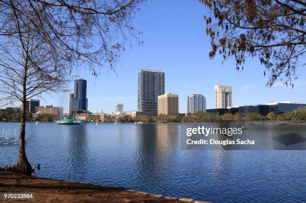 orlando city skyline from lake eola park - cleveland ohio flats stock pictures, royalty-free photos & images