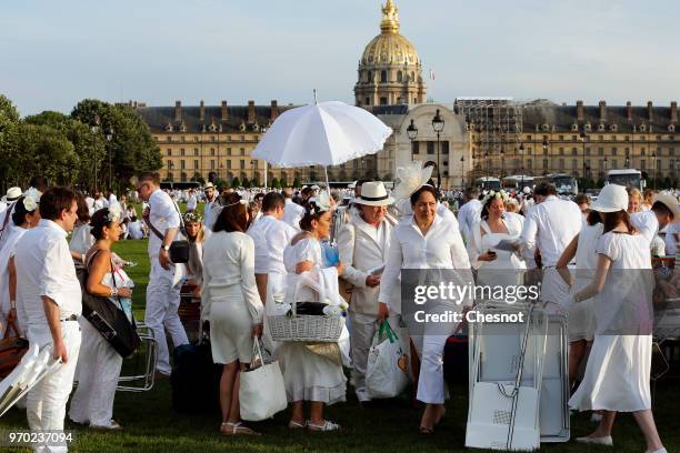 People dressed in white gather for the 30th edition of the 'Diner En Blanc' event on the Invalides esplanade on June 3, 2018 in Paris, France. The...