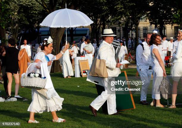 People dressed in white gather for the 30th edition of the 'Diner En Blanc' event on the Invalides esplanade on June 3, 2018 in Paris, France. The...