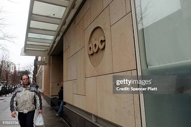 People walk by the ABC headquarters on February 24, 2010 in New York, New York. ABC has announced that the television news division plans to cut...