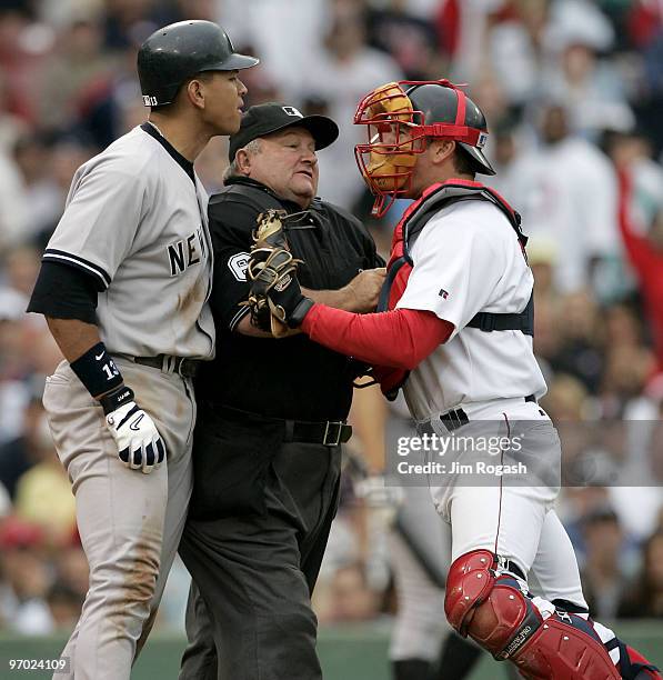 Home plate umpire Bruce Froemming, attempts to keep Boston Red Sox catcher Jason Varitek, right, away New York Yankees batter Alex Rodriguez in the...