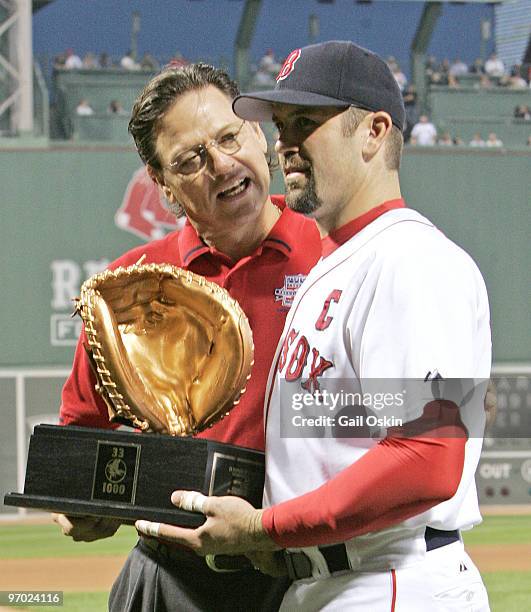 Boston Red Sox catcher Jason Varitek, right and Hall of Famer Carlton Fisk, left, acknowledge the crowd after Varitek was honored for becoming the...