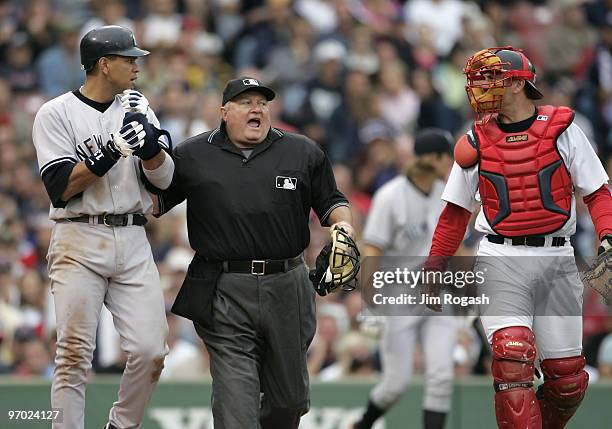 Home plate umpire Bruce Froemming, attempts to keep Boston Red Sox catcher Jason Varitek, right, away New York Yankees batter Alex Rodriguez in the...