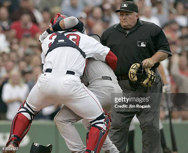 Boston Red Sox catcher Jason Varitek, right, wrestles New York Yankees batter Alex Rodriguez at Fenway Park in Boston. The two fought after Rodriguez...
