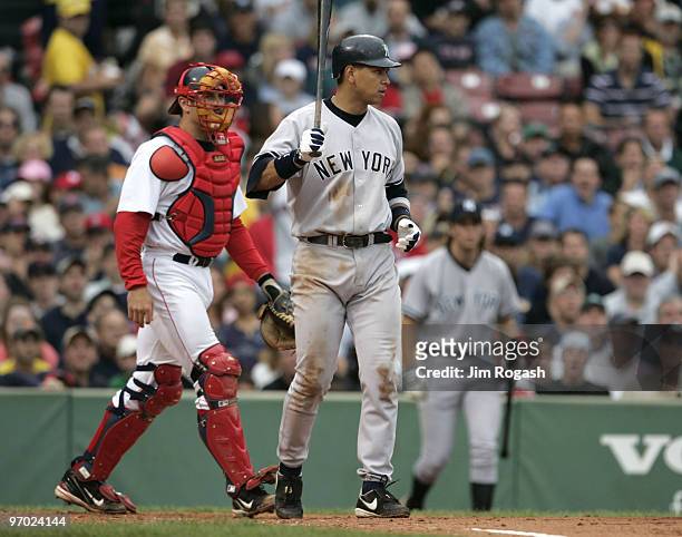 Under the watchful eyes of Boston Red Sox catcher Jason Varitek, New York Yankees batter Alex Rodriguez raises his bat in the direction of Red Sox...