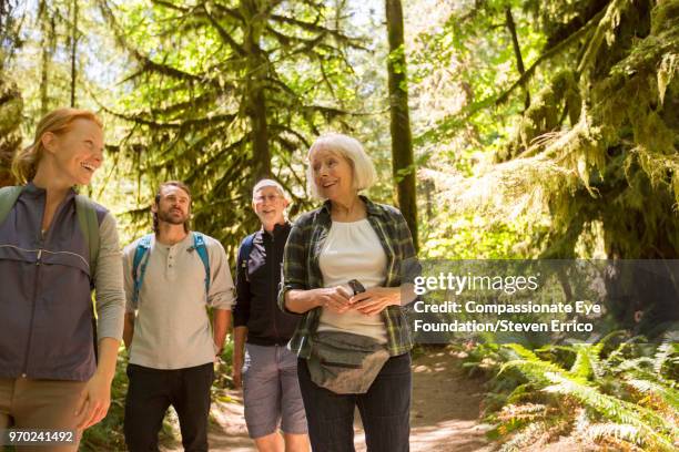 senior couple and family hiking in forest - pulsante di apertura o di chiusura foto e immagini stock