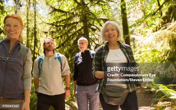 senior couple and family hiking in forest - pulsante di apertura o di chiusura foto e immagini stock