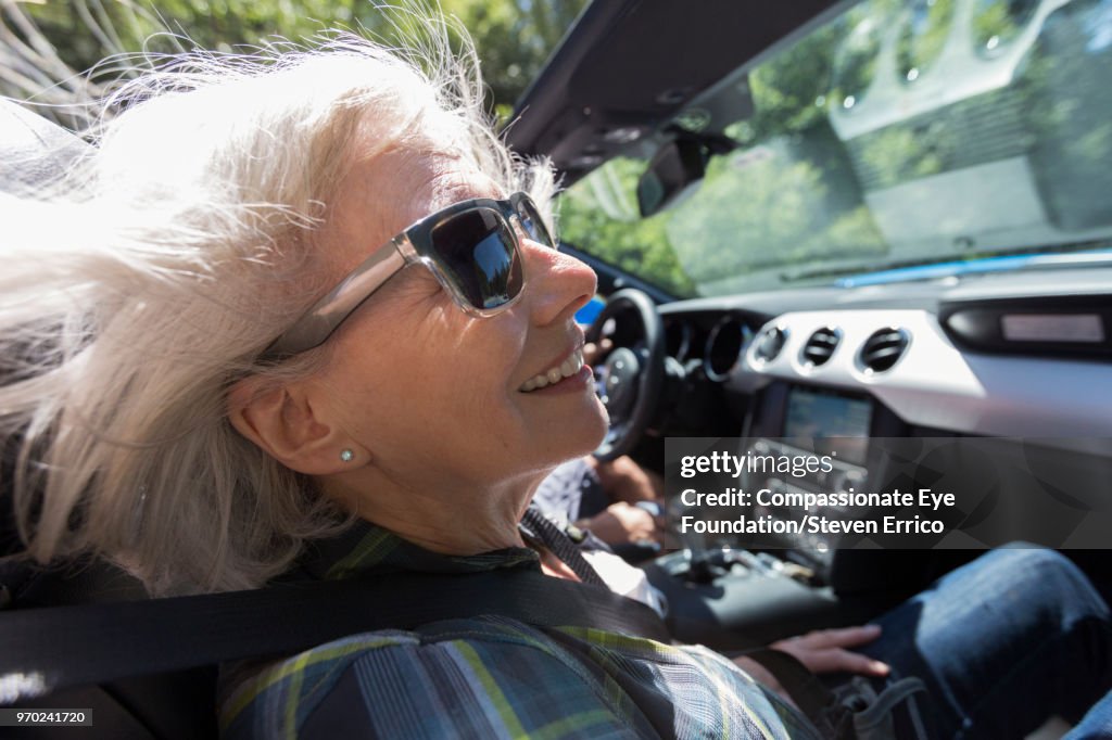 Senior woman driving in convertible