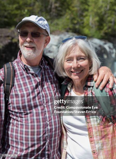 portrait of smiling senior couple hiking in mountains - open or close button stock pictures, royalty-free photos & images