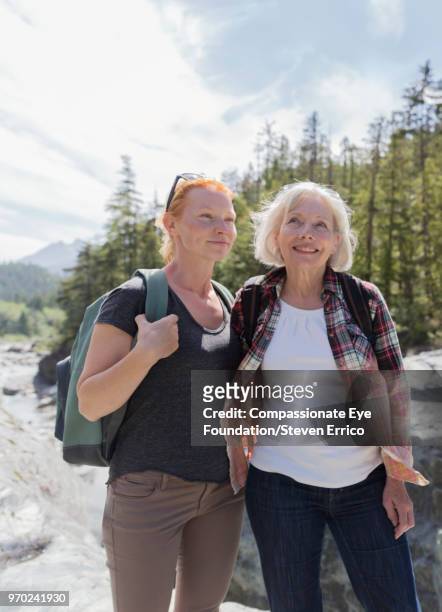 senior woman and daughter hiking in mountains - öppna och stäng knapp bildbanksfoton och bilder