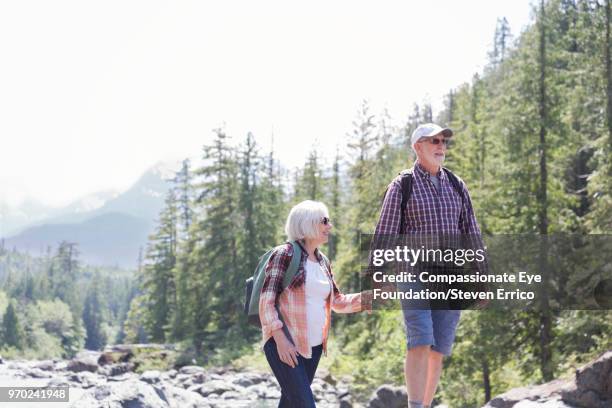 senior couple hiking in mountains - open or close button stock pictures, royalty-free photos & images