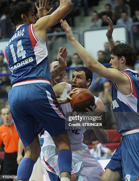 Olympiacos's Mavrokefalides Loukas vies with Cibona's Dalibor Bagaric and Marko Tomasduring their Euroleague basketball match Olympiacos vs Cibona in...