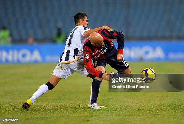 Alexis Alejandro Sanchez competes with Andrea Parola of Cagliari during the Serie A match between Udinese Calcio and Cagliari Calcio at Stadio Friuli...