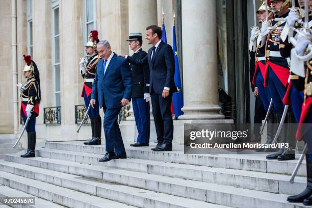 French President Emmanuel Macron escorts the Israeli Prime Minister Benjamin Netanyahu , after a meeting and a press conference at Elysee Palace on...