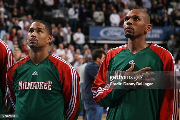 Charlie Bell and Jerry Stackhouse of the Milwaukee Bucks line up on the court before the game against the Dallas Mavericks at the American Airlines...