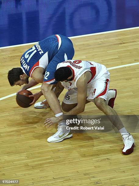 Luksa Andric of Cibona competes with Ioannis Bourousis of Olympiacos Piraeus during the Euroleague Basketball 2009-2010 Last 16 Game 4 between KK...