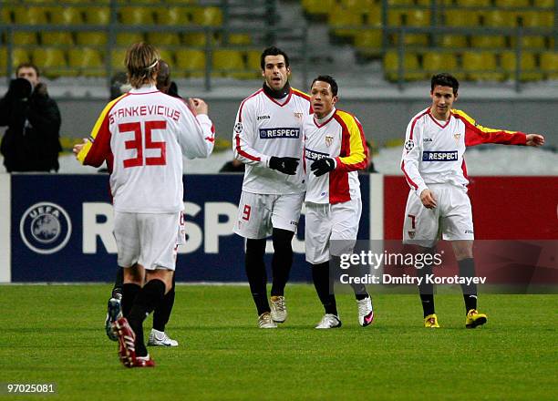 Alvaro Negredo of Sevilla celebrates with teammates after scoring the opening goal of the UEFA Champions League round of sixteen, first leg match...