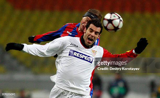 Vasili Berezutski of PFC CSKA Moskva competes for a header with Alvaro Negredo of Sevilla FC during the UEFA Champions League round of sixteen, first...