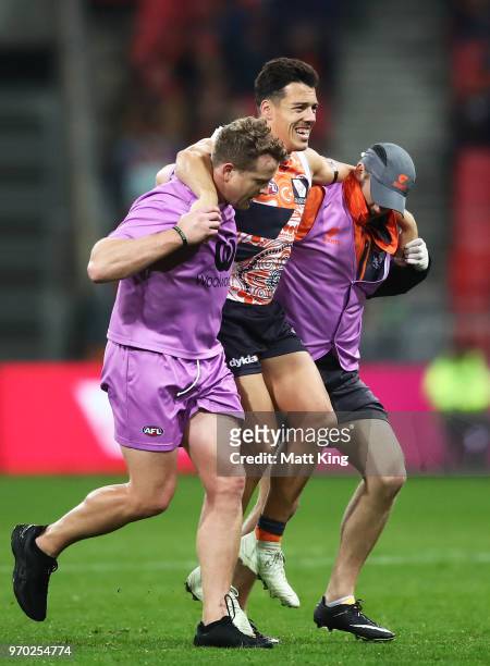 Dylan Shiel of the Giants leaves the field with an injury during the round 12 AFL match between the Greater Western Sydney Giants and the Gold Coast...