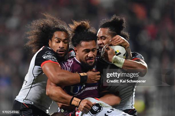 Jorge Taufua of the Sea Eagles is tackled by Bunty Afoa of the Warriors and Solomone Kata of the Warriors during the round 14 NRL match between the...