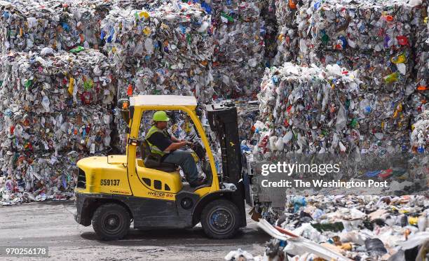 Forklift operator is seen stacking bales of recyclables at the Waste Management Elkridge Material Recycling Facility on June 18, 2015 in Elkridge,...