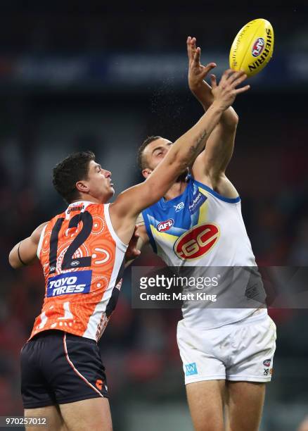 Jonathon Patton of the Giants competes for the ball against Jarrod Witts of the Suns during the round 12 AFL match between the Greater Western Sydney...