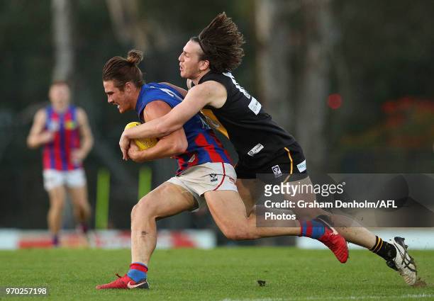 Khan Haretuku of Port Melbourne is tackled by Josh Porter of Werribee during the round 10 VFL match between Werribee and Port Melbourne at Avalon...