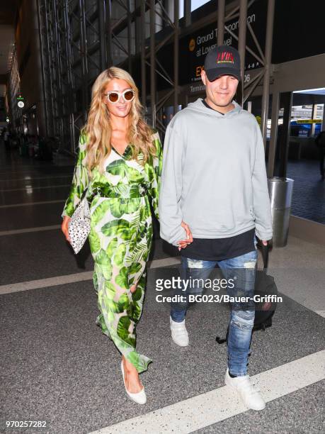 Paris Hilton and Chris Zylka are seen at Los Angeles International Airport on June 08, 2018 in Los Angeles, California.