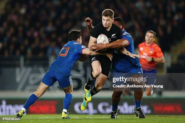 Beauden Barrett of the All Blacks on the charge against Anthony Belleau of France during the International Test match between the New Zealand All...