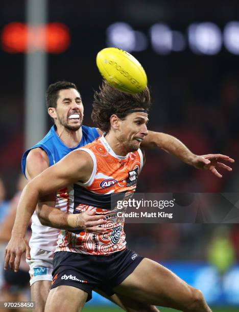 Ryan Griffen of the Giants is challenged by Michael Rischitelli of the Suns during the round 12 AFL match between the Greater Western Sydney Giants...