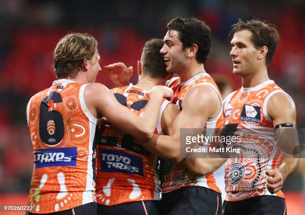Josh Kelly of the Giants celebrates with team mates after kicking a goal during the round 12 AFL match between the Greater Western Sydney Giants and...
