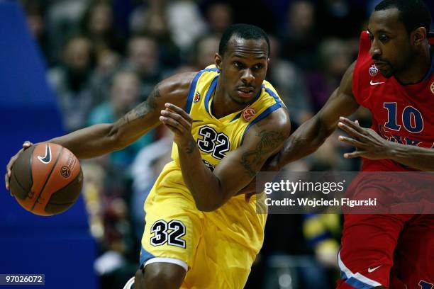 Daniel Ewing of Asseco Prokom competes with JR Holden, #10 of CSKA Moscow during the Euroleague Basketball 2009-2010 Last 16 Game 4 between Asseco...