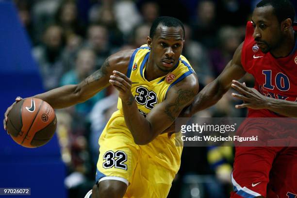 Daniel Ewing of Asseco Prokom competes with JR Holden, #10 of CSKA Moscow during the Euroleague Basketball 2009-2010 Last 16 Game 4 between Asseco...
