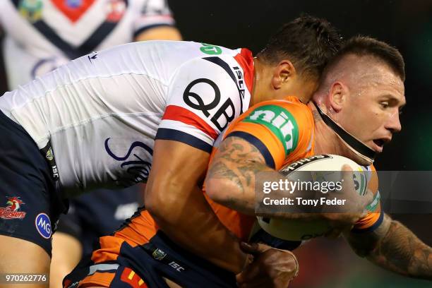 Shaun Kenny-Dowall of the Knights is tackled during the round 14 NRL match between the Newcastle Knights and the Sydney Roosters at McDonald Jones...