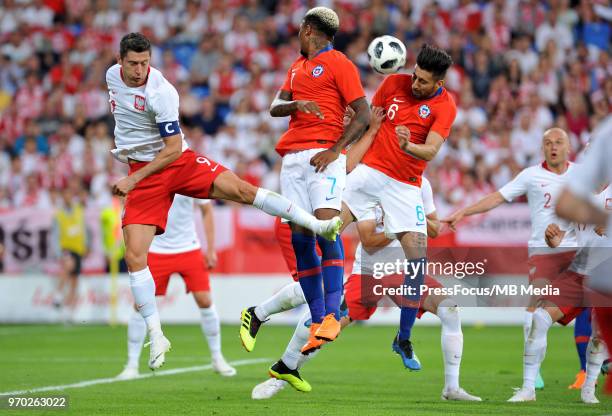 Robert Lewandowski of Poland competes with Guillermo Maripan of Chile during International Friendly match between Poland and Chile on June 8, 2018 in...