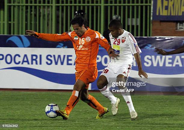 Iran's Mes Kerman club player Amir Kamdar vies with Ali Hussein of the United Arab Emirates' Al-Ahly club during their AFC Champions League football...