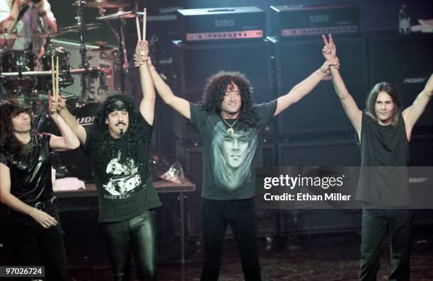 Quiet Riot bassist Rudy Sarzo, drummer Frankie Banali, frontman Kevin DuBrow, and guitarist Carlos Cavazo take a curtain call after performing at The...