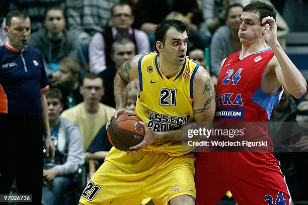 Ratko Varda, #21 of Asseco Prokom competes with Sasha Kaun, #24 of CSKA Moscow in action during the Euroleague Basketball 2009-2010 Last 16 Game 4...