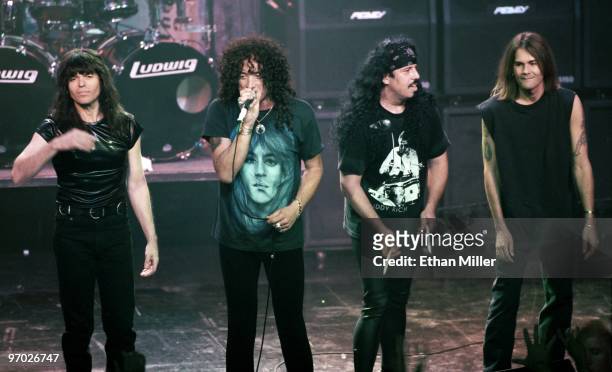 Quiet Riot bassist Rudy Sarzo, drummer Frankie Banali, frontman Kevin DuBrow, and guitarist Carlos Cavazo take a curtain call after performing at The...