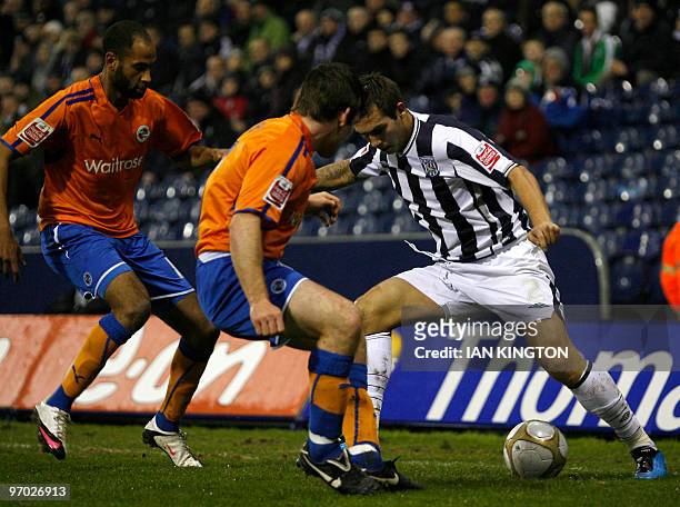 West Bromwich Albion's Belgium footballer Carl Hoefkens vies for the ball with Reading's Jay Tabb and Reading's Jimmy Kebe during their FA Cup fifth...