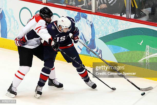 Bobby Ryan of the United States hanldes the puck against Mark Streit of Switzerland during the ice hockey men's quarter final game between USA and...