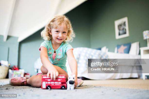 portrait of girl playing with toys at home - play bus stock pictures, royalty-free photos & images