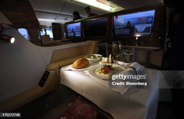 Meal sits on a travellers tray in the business class cabin on board a Boeing Co. 777-300ER passenger jetliner, operated by Emirates Airline, at...