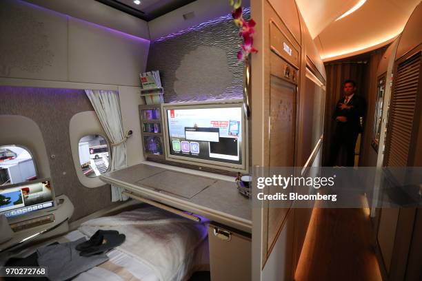 Nightwear and slippers lay on a bed in a first class private suite on board a Boeing Co. 777-300ER passenger jetliner, operated by Emirates Airline,...