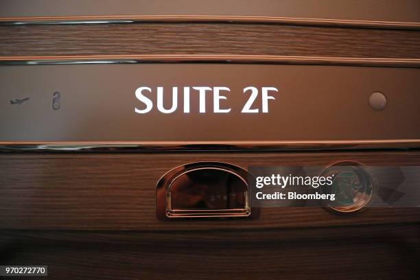 Sign reading 'Suite 2F' sits displayed outside a first class private suite on board a Boeing Co. 777-300ER passenger jetliner, operated by Emirates...