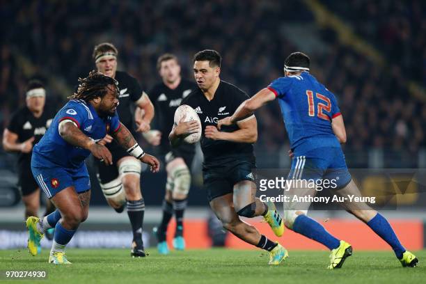 Anton Lienert-Brown of the All Blacks makes a run against Mathieu Bastereaud and Geoffrey Doumayrou of France during the International Test match...