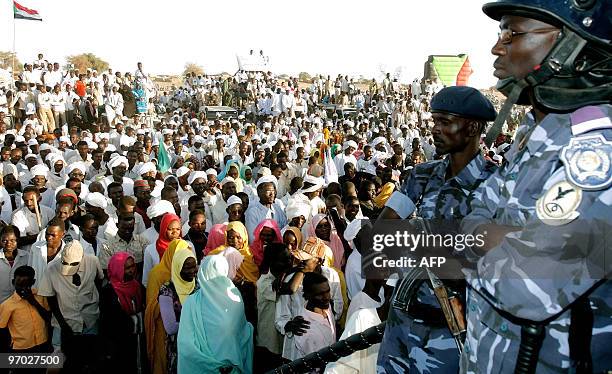 Sudanese policemen stand guard as thousands gather at a rally attended by President Omar al-Beshir in El-Fasher, the capital of North Darfur state,...