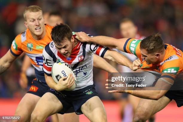 Luke Keary of the Roosters is tackled during the round 14 NRL match between the Newcastle Knights and the Sydney Roosters at McDonald Jones Stadium...