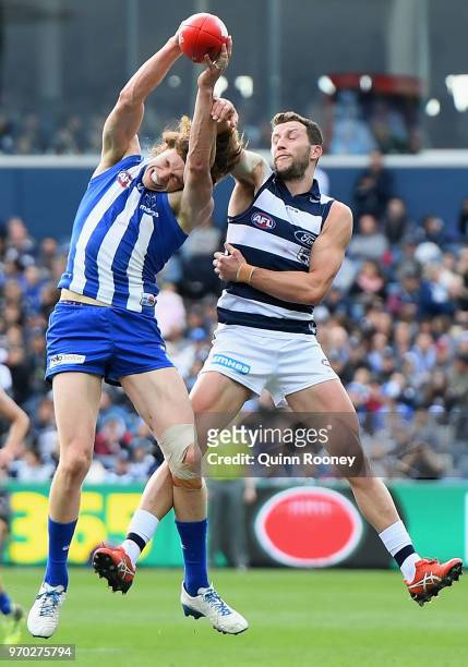 Ben Brown of the Kangaroos marks infront of Sam Menegola of the Cats during the round 12 AFL match between the Geelong Cats and the North Melbourne...